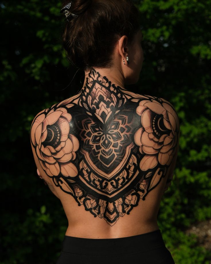 a woman with tattoos on her back