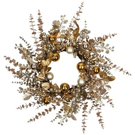 a christmas wreath with ornaments hanging from it's sides and greenery around the edges