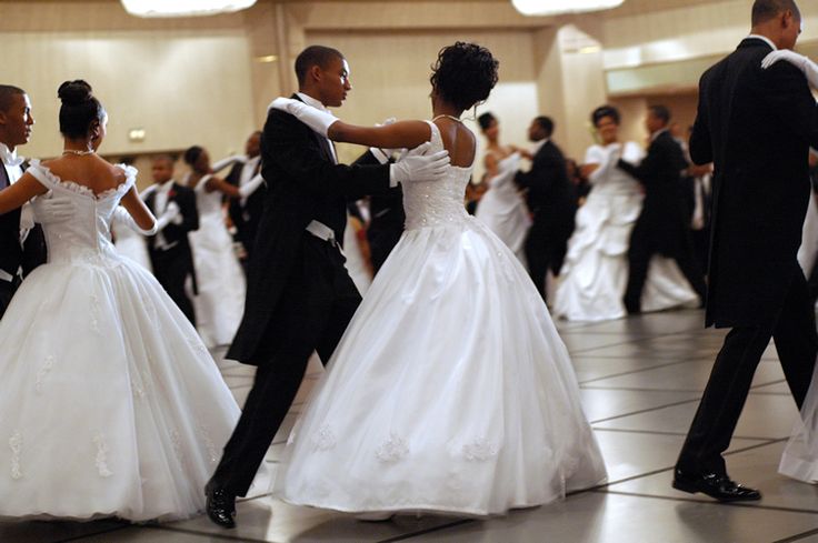 a group of people in formal wear dancing