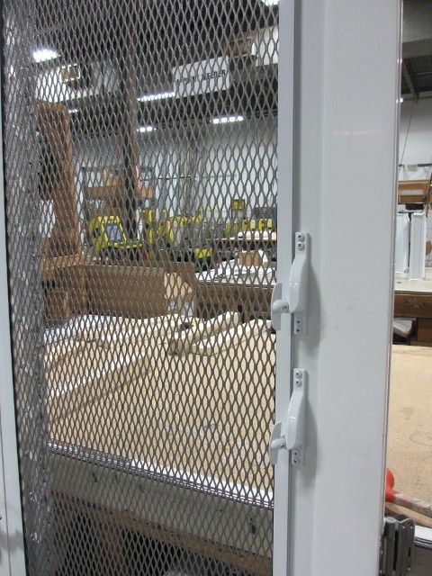 the door is open to reveal an enclosed area with construction equipment in the back ground