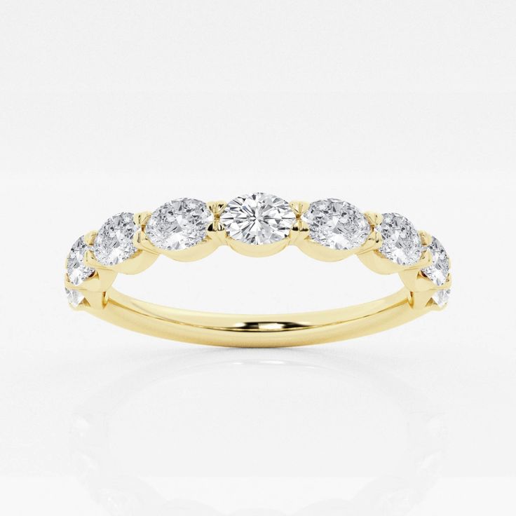 a yellow gold wedding ring with five diamonds