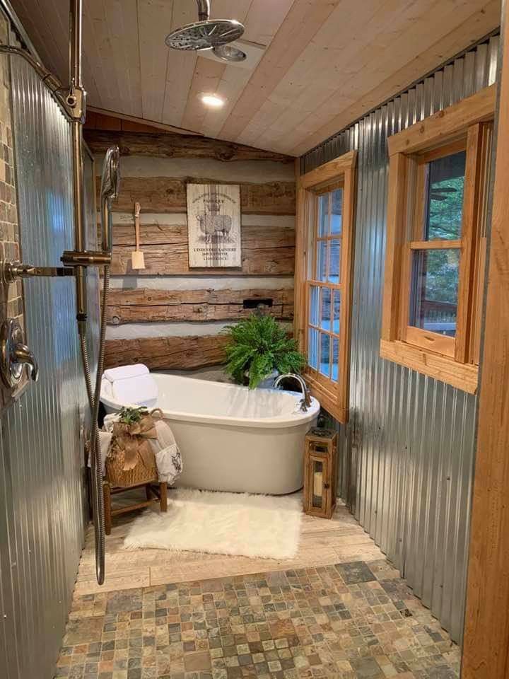 a bathroom with a bathtub, toilet and window in it's side wall