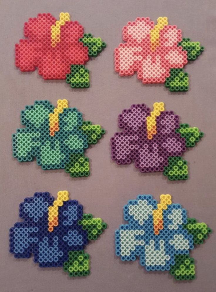 cross stitch flowers are shown in different colors