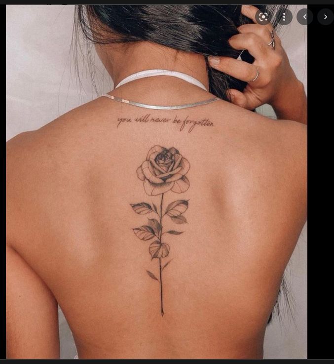 a woman with a rose tattoo on her back