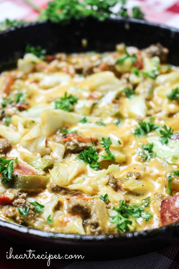 a skillet filled with pasta and vegetables