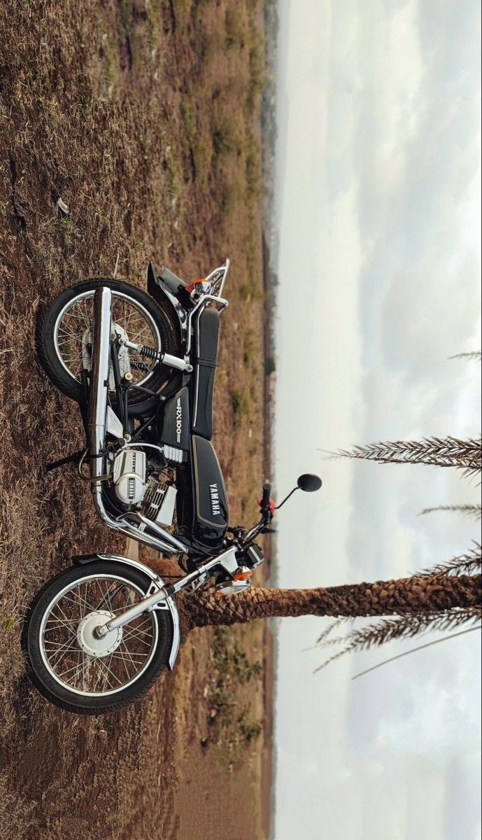 a motorcycle parked on top of a grass covered field