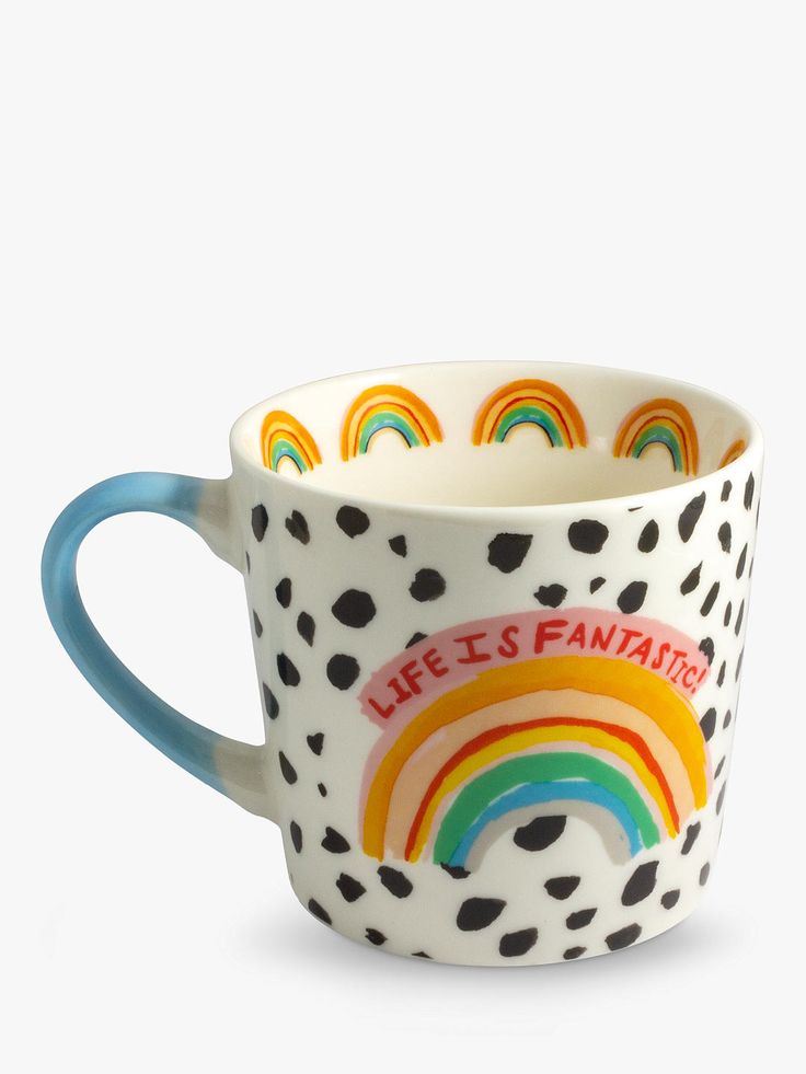 a coffee cup with a rainbow painted on the side and words life's fantasy