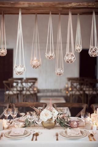 the table is set with candles, plates and napkins for an elegant wedding reception