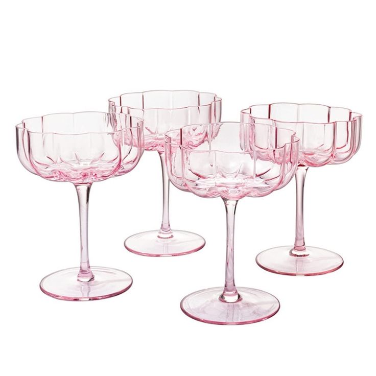 four pink wine glasses sitting on top of each other