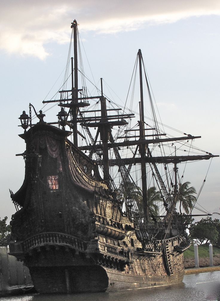 an old pirate ship is docked in the water