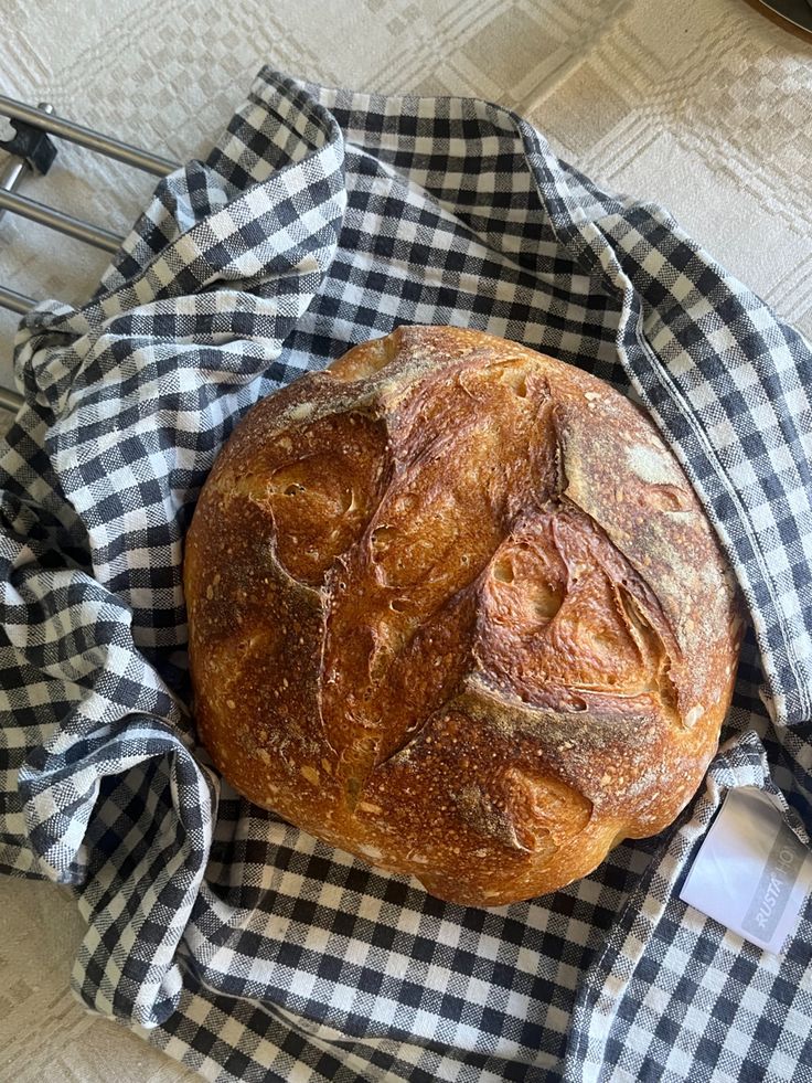 a loaf of bread sitting on top of a black and white checkered cloth