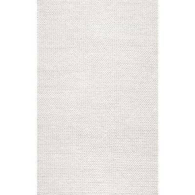 a white rug with small dots on it