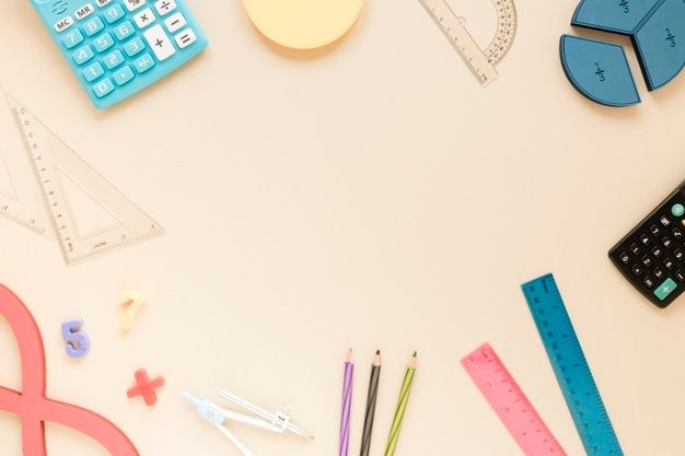 various school supplies laid out on a table with ruler, calculator and pencils