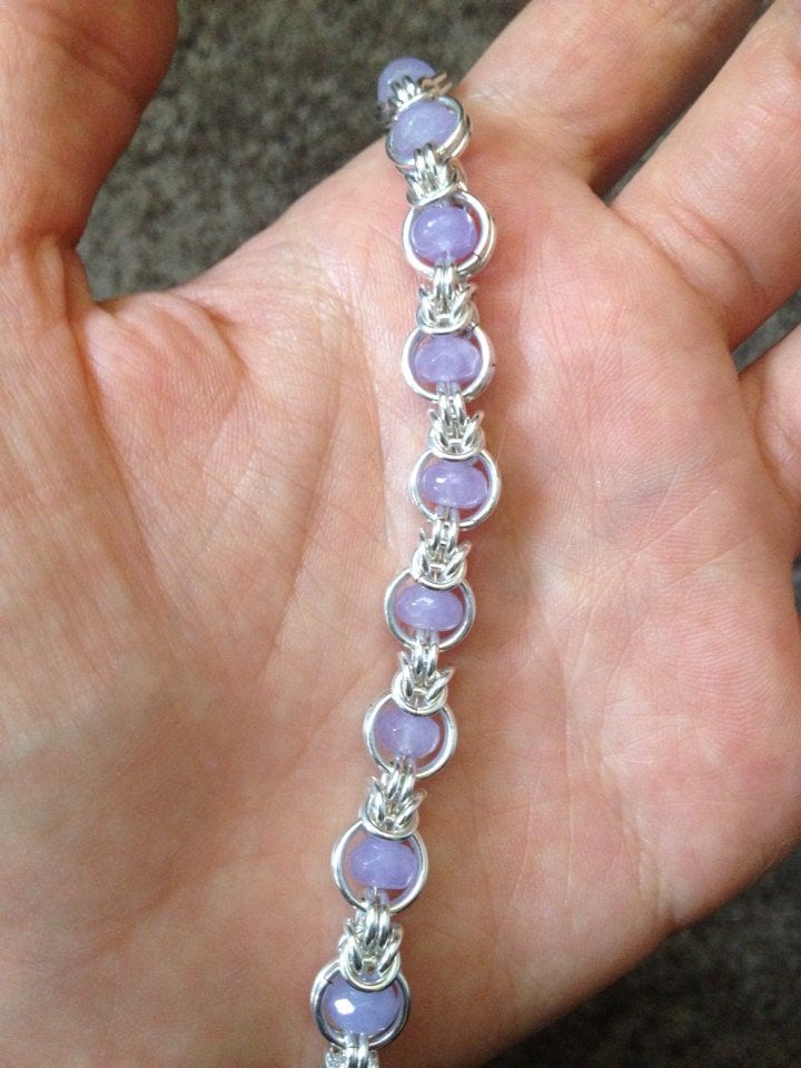 "This beautiful bracelet was made using the \"Dreaming in Mail\" pattern.   Bracelet is made from sterling silver filled jump rings, high quality lavender agate rondelles, and is a beautiful, feminine interpretation on chainmaille!  Bracelet is 7.5\" long, clasped with an elegant sterling silver lobster, and can be adjusted shorter if need be.  I hope you love your new bracelet, and feel free to contact me with any questions!  Infinite Love and Gratitude!  *See something you like here, but had a Wire Bead Bracelet, Jump Ring Bracelet, Chainmaille Jewelry Patterns, Chain Maille Patterns, Jump Ring Jewelry, Chainmaille Jewelry, Chainmail Bracelet, Tiffany And Co Jewelry, Pattern Bracelet