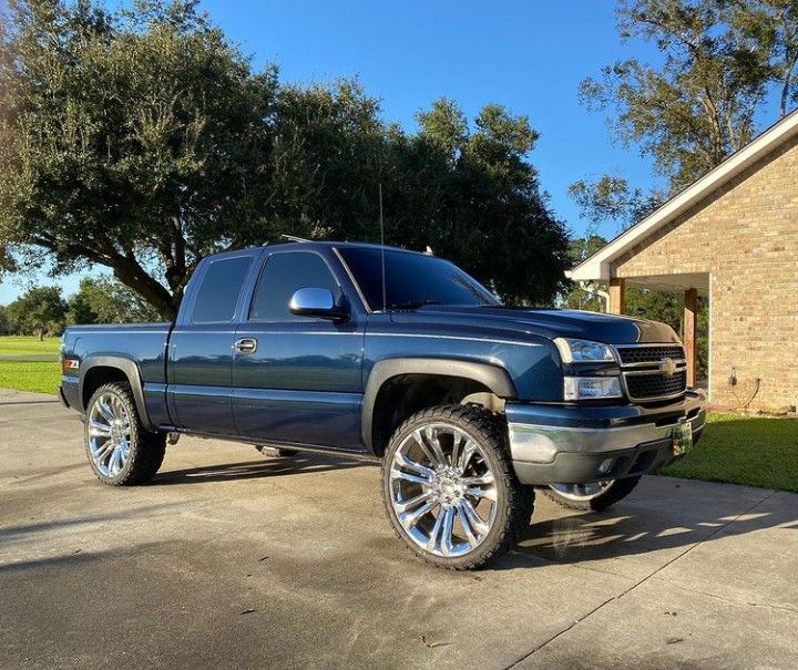 a blue truck parked in front of a house