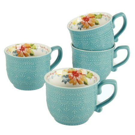 four blue mugs with floral designs on them