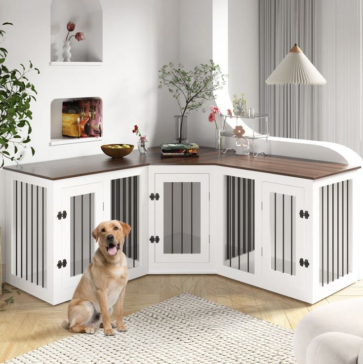 a dog sitting on the floor in front of a white cabinet with doors and drawers