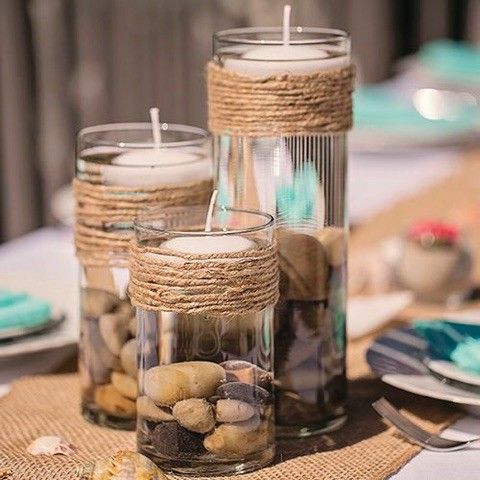 candles are sitting in glass containers on a table