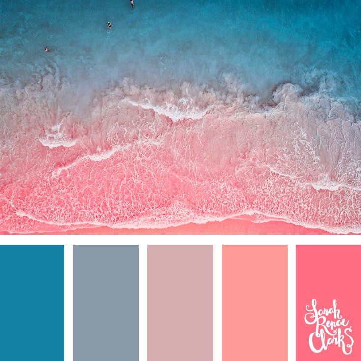 an aerial view of the ocean with pink and blue colors