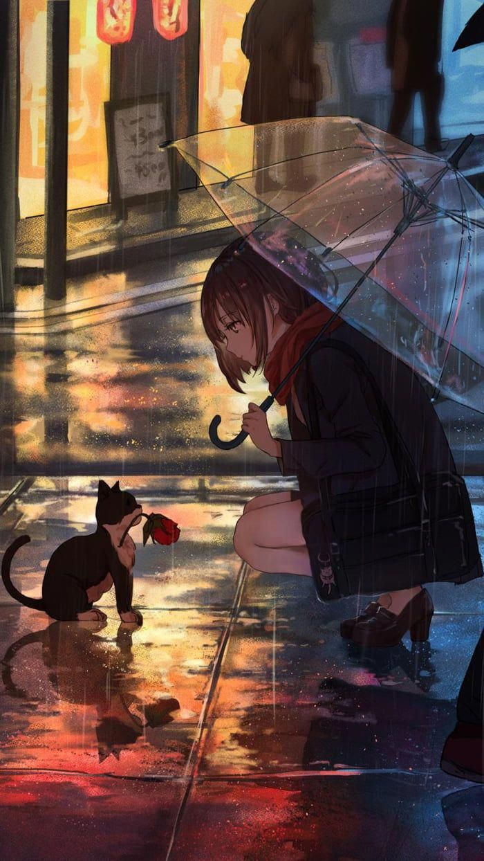 a woman kneeling down next to a cat under an umbrella