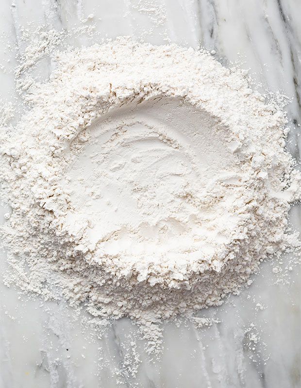 flour in a bowl on a marble surface