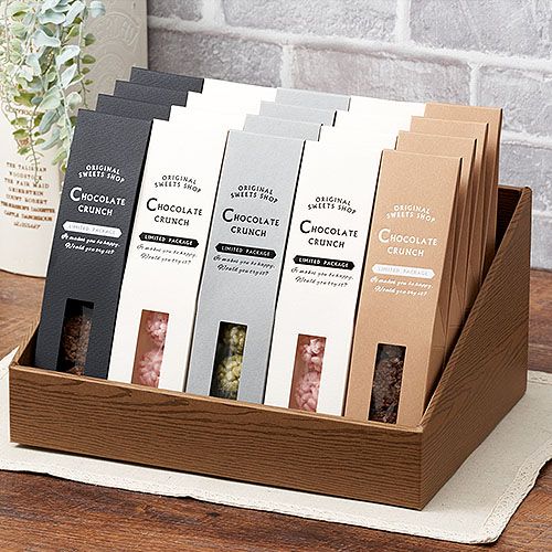 six chocolate bars in a wooden holder on a table