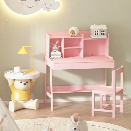 a child's desk and chair in a room with white walls, wooden floors and pink furniture