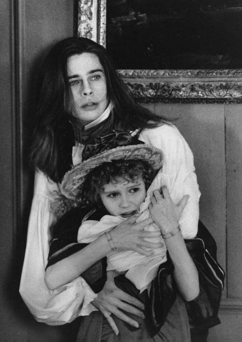 a woman holding a child in her arms