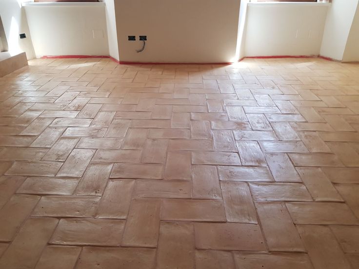 an empty room with tile floors and windows