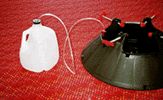 two black and white jugs sitting on top of a red table cloth next to a silver kettle