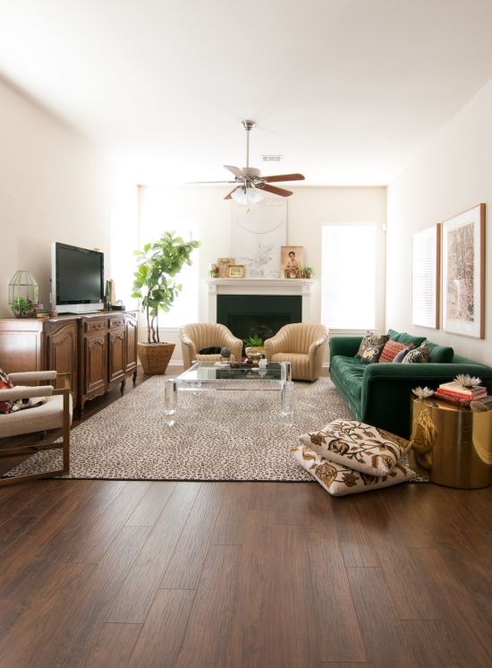 a living room filled with furniture and a flat screen tv on top of a wooden floor