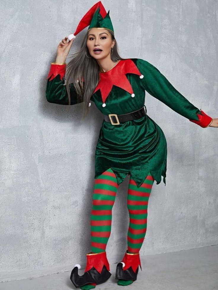 a woman dressed in an elf costume posing for the camera