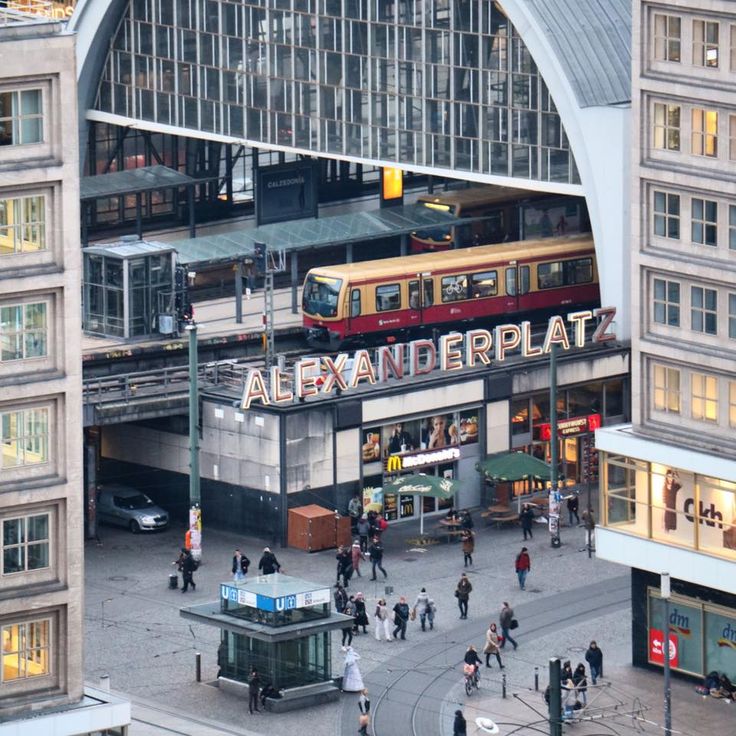 an overhead view of a train station with people walking around