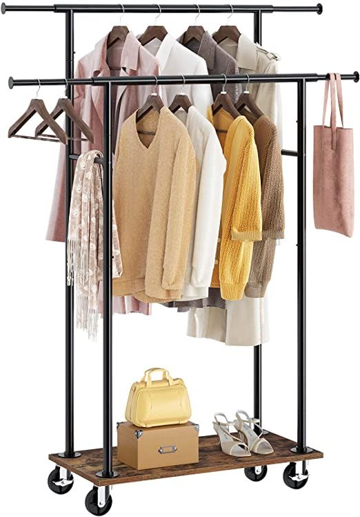 the garment rack is holding several sweaters and shoes