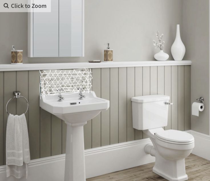 a white toilet sitting next to a sink in a bathroom on top of a hard wood floor