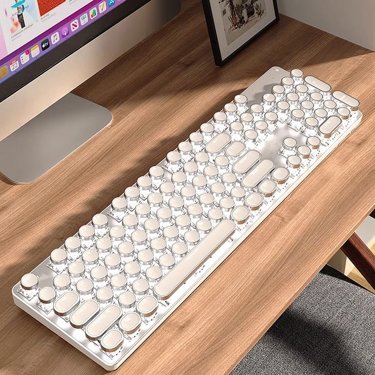 a computer keyboard sitting on top of a wooden desk