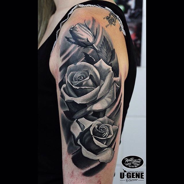 a black and white rose tattoo on the arm