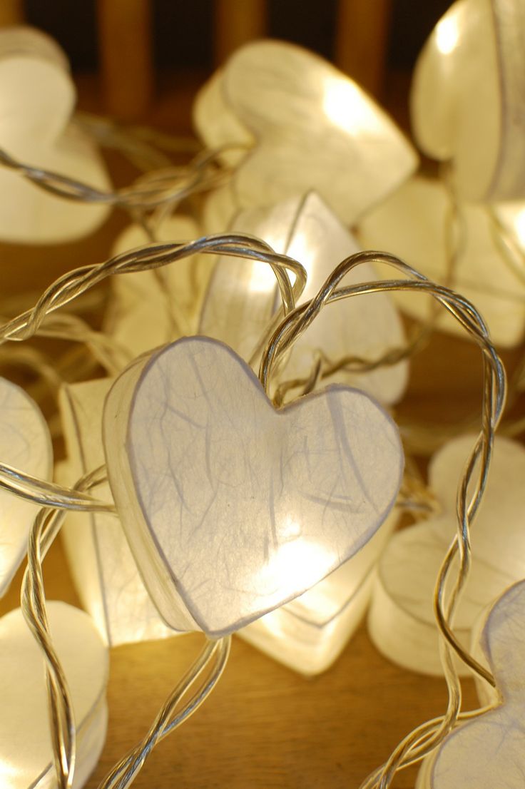 white heart shaped string lights on a wooden table