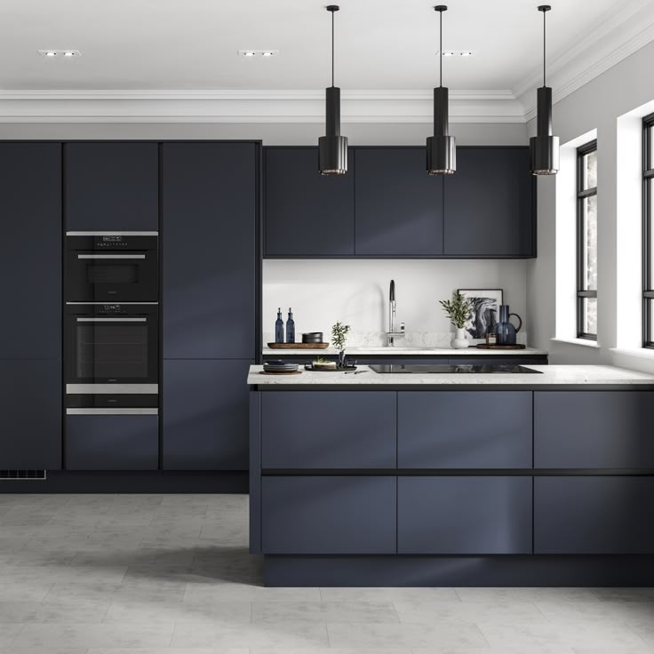 a modern kitchen with dark blue cabinets and white counter tops, along with stainless steel appliances