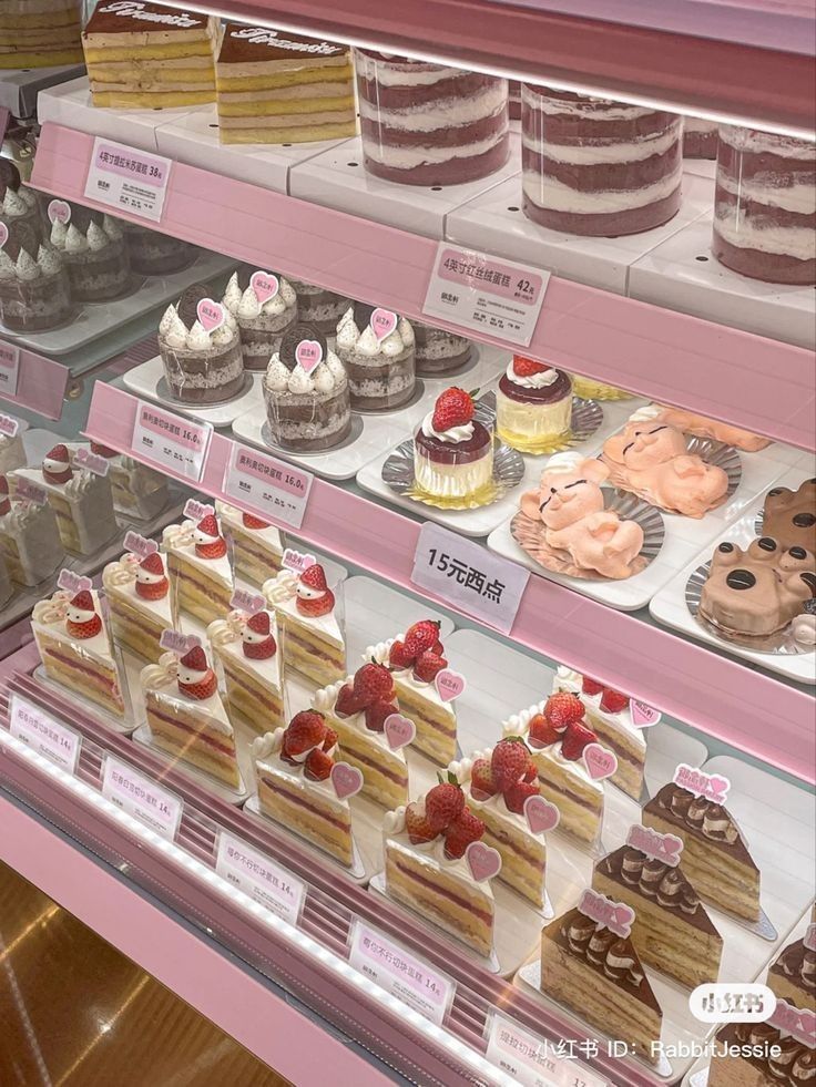 a display case filled with lots of different types of cakes