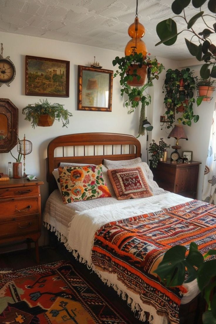 a bed sitting in a bedroom next to a window with plants on the wall above it