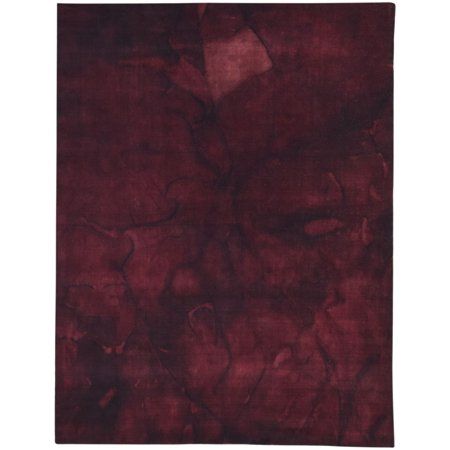 a red rug with an abstract design on the top and bottom, it is very dark purple