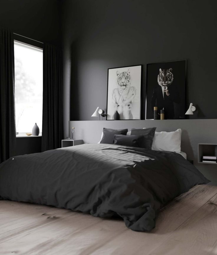 black and white bedroom with wooden flooring and artwork on the wall above the bed