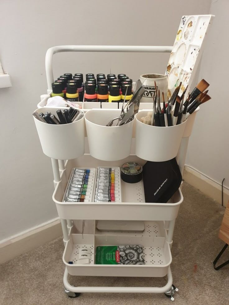 a white cart filled with lots of art supplies