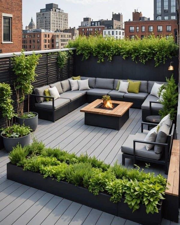 an outdoor living area with couches, tables and potted plants on the roof