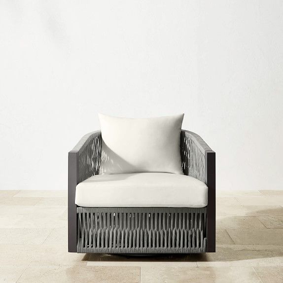 a chair with a white pillow sitting on it's back and armrests