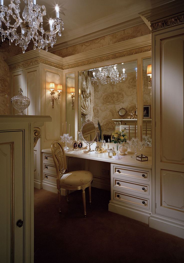 an elegant dressing room with chandelier and vanity