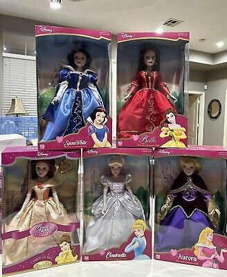 four disney princess dolls in their boxes