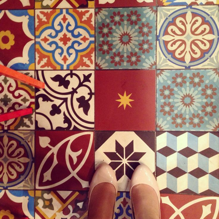 a person standing on top of a tiled floor