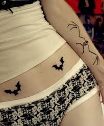 a woman's stomach with a cat tattoo on her lower body and the bottom part of her panties